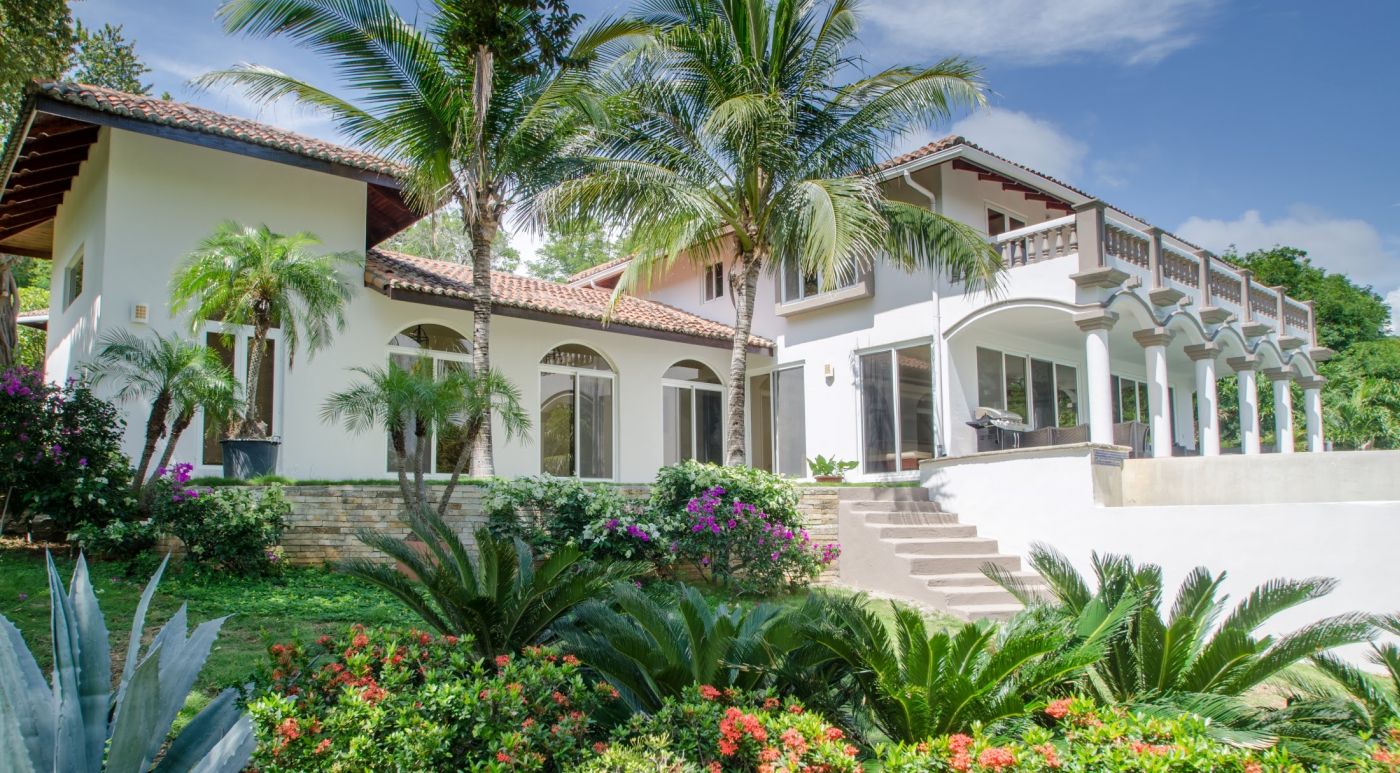 View of Casa Guacalito’s beach terrace from the lush garden.
