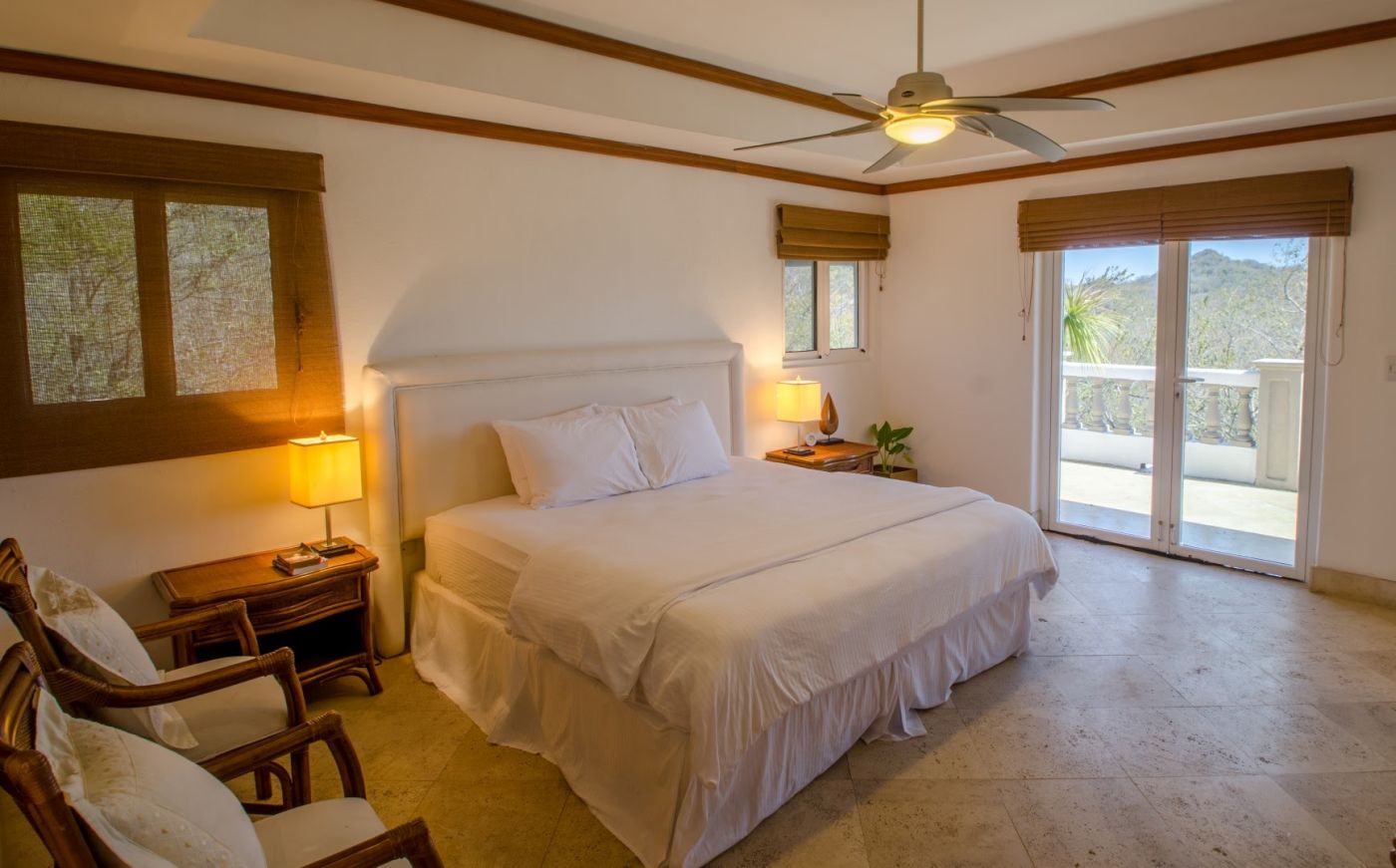 Bedroom 1 at Casa Guacalito showcasing a king-size bed and tile flooring.